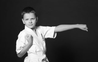 Boy in karate stance in unform