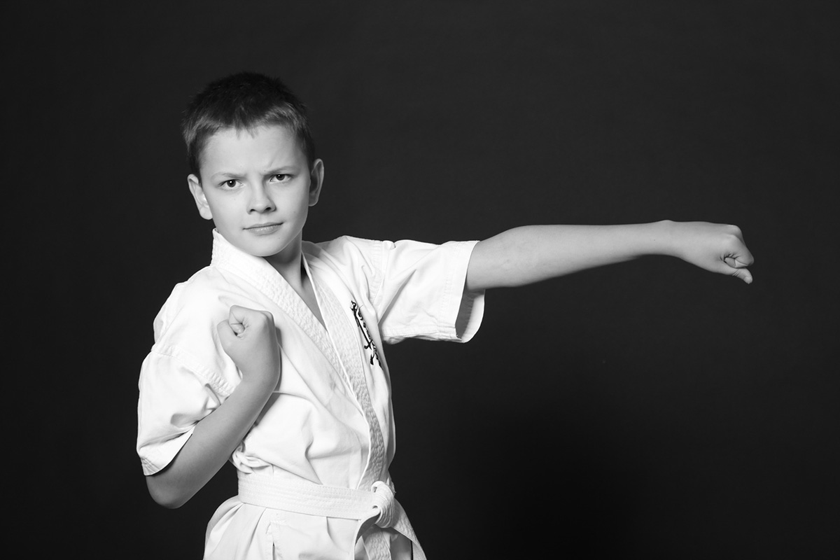 Boy in karate stance in unform